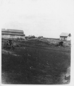 Khutor farm had one section (160 & 160 acres). Implement shed for machinery: thresher, steam engine, wagon, sleigh. Building on right was a grainery. Khutor farm